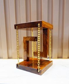 a wooden object with chains attached to it