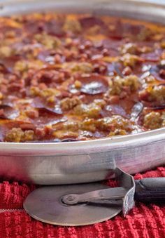 a large metal pan filled with food on top of a red towel