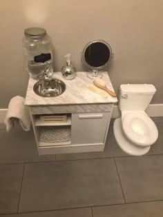 a white toilet sitting next to a sink in a bathroom