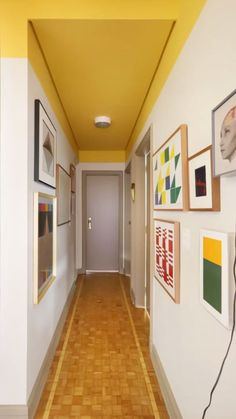 an empty hallway with pictures on the wall