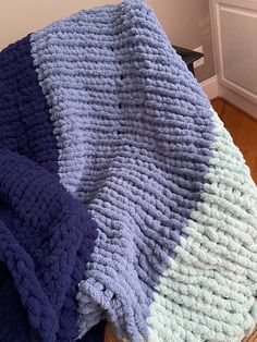 there is a blue and purple blanket on the floor