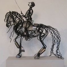 a sculpture of a horse that has been made out of wires and is standing on its hind legs