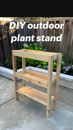 a wooden shelf sitting on the side of a sidewalk next to a flower potted planter