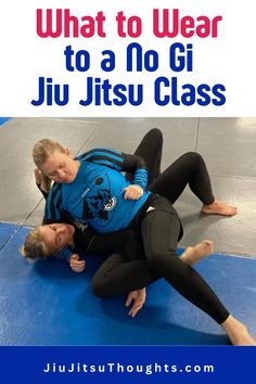 two women in blue shirts and black pants are wrestling with the words what to wear to a no gi ji ji class