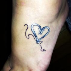 a heart shaped balloon tattoo on the foot