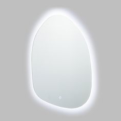 an oval shaped mirror is lit up by the light coming from it's side