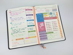 an open planner book with colorful stickers on it