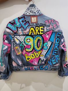 a denim jacket with graffiti written on it