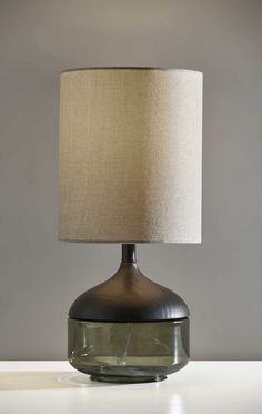 a table lamp with a beige shade on it