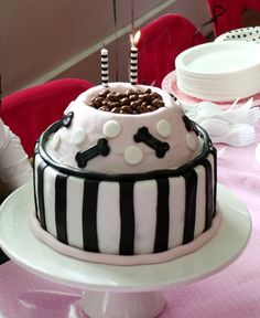 a birthday cake is decorated with black and white striped frosting, topped with chocolate chips