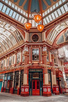 the inside of a building with many windows and lights hanging from it's ceiling