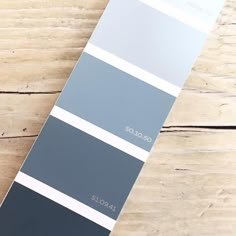 a pantone color swatch sitting on top of a wooden table