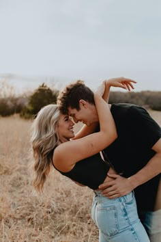 a man and woman embracing in a field