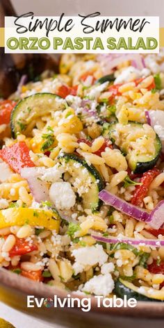 a bowl filled with pasta and vegetables on top of a table