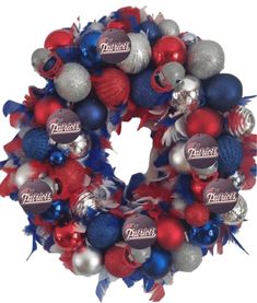 a wreath that is decorated with red, white and blue ornaments