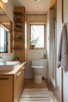 a bathroom with a toilet, sink, and shower in it's own area