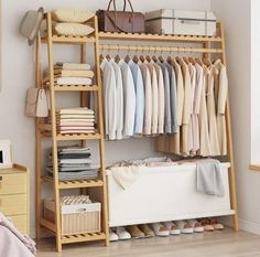 an organized closet with clothes, shoes and other items on the shelves next to a bed