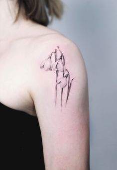 a woman with a tattoo on her shoulder