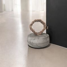 an object is sitting on the floor in front of a black door and white walls