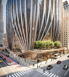 an artisticly designed building in the middle of a busy street with cars and pedestrians