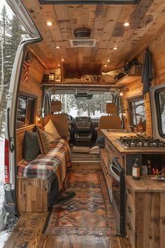 the interior of an rv with wood paneling and plaid blankets on the bed area