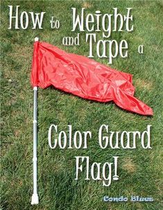 a red flag laying on top of a green field