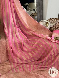 Indulge in luxury and elegance with our Banarasi Khaddi georgette saree in beautiful pink stripes. Handcrafted with intricate details, this saree exudes exclusivity and sophistication. Perfect for any occasion, this saree elevates your style and adds a touch of glamour to your wardrobe. Saree comes with a blouse piece. Fall and pico done. Fully stitched blouse shown in pictures is optional and can be purchased seperately from our blouses and croptops section. For saree video please connect with us on whatsapp @469-937-0606 Ready to be shipped in USA from San Diego, California. All pictures are original pictures. Colors may slightly vary due to pic resolution. Pink Bollywood Georgette Saree, Bollywood Style Pink Georgette Saree, Pink Georgette Saree With Zari Work, Pink Georgette Saree For Festivals, Pink Georgette Saree With Traditional Drape, Pink Georgette Traditional Wear With Cutdana, Pink Georgette Saree With Self Design, Traditional Pink Georgette Saree, Pink Pre-draped Saree For Eid Ceremonies