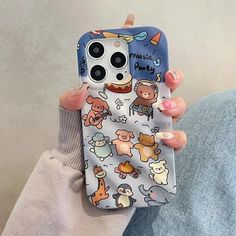 a woman holding up her phone case with cartoon animals on it, and the back cover is