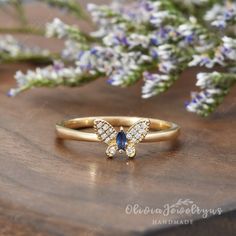 a yellow gold ring with blue and white diamonds