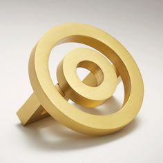 an object made out of wood on a white surface with a circular shape in the middle