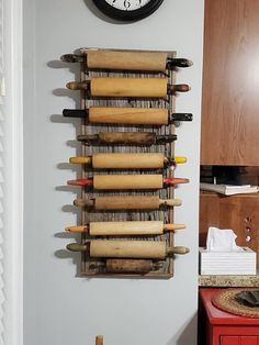 a clock mounted to the side of a wall next to rolling dough and rolling pins