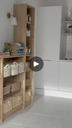 a kitchen with lots of shelves and baskets on the counter top in front of it