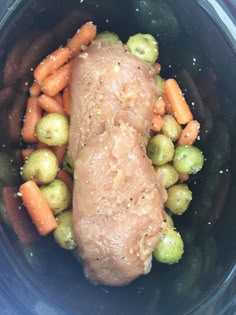 a meat and vegetables in a crock pot with seasoning on top, ready to be cooked