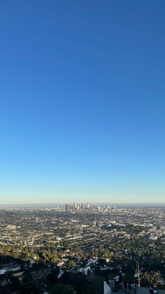 a view of the city skyline from atop a hill in los angeles, with skyscrapers visible