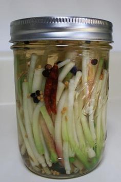 a jar filled with pickled onions and other vegetables