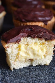 a close up of a muffin with chocolate frosting on the outside and inside