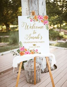 a welcome sign is sitting on top of a wooden easel