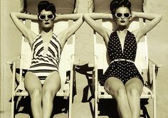 two women in bathing suits sitting on beach chairs with their arms behind each other and the words, beauty in voyage open air