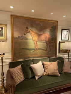 a living room filled with furniture and a painting on the wall above it's couch