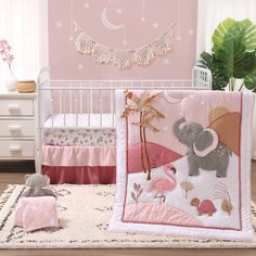 a baby crib bedding set with an elephant and giraffe