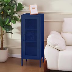 a blue cabinet sitting next to a white couch