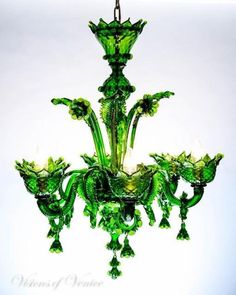 a green chandelier hanging from a ceiling