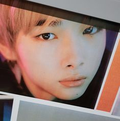 an image of a woman with blue eyes and pink hair on display in a store window