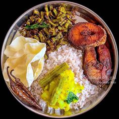 a plate filled with rice, beans and other foods