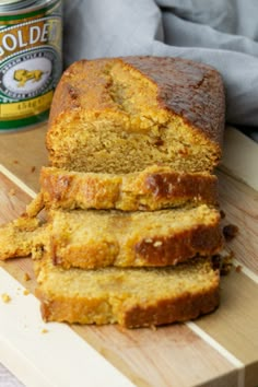 sliced loaf of banana bread sitting on top of a cutting board next to a jar of honey