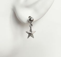 "Dull silver tone star charm earrings. Small star charms dangling from stainless steel ball earring studs. Earring length: 18mm; 0.7\" (including the ball of the stud) Earring stud material: stainless steel Charm material: Zinc alloy, Nickel safe, Lead free This listing is for one pair of star earrings with rubber backs. These earrings will come in a gift bag. I offer combined shipping costs which give you a shipping discount for ordering multiple items from my shop. Earrings care: Take them off Cute Dangle Earrings With Star Charm, Silver Star Earrings With Charms, Cheap Cute Star-shaped Earrings, Star-shaped Earrings With Dangling Charms As Gift, Star-shaped Earrings With Dangling Charms For Gift, Silver Star Clip-on Earrings For Gift, Ball Stud Earrings, Earring Stud, Earring Studs