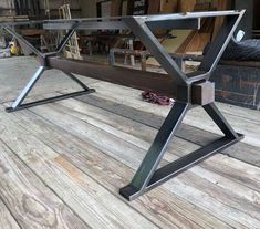 a metal table sitting on top of a wooden floor