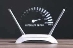 an internet speedometer sitting on top of a wooden table