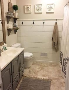 a bathroom with a toilet, sink and shower in it's centerpieces