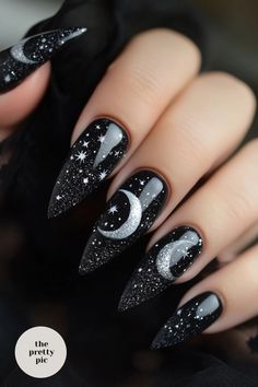 Get inspired for Halloween with these spooky and stylish nail designs perfect for the season. From eerie pumpkins to haunting ghosts, these Halloween nails acrylic ideas will make your manicure stand out. Whether you prefer cute and playful or creepy and dark, there's a halloween nails design here for everyone to try out this season. Let your fingertips show off your Halloween spirit with these creative and unique nail designs that are sure to impress all the ghouls and goblins around you! Subtle Black Halloween Nails, Glitter Spooky Nails, Witchy Inspired Nails, Silver Chrome Halloween Nails, Moon Acrylic Nail Designs, Salem Inspired Nails, Black Nail Designs Fall, Halloween Nails With Stickers